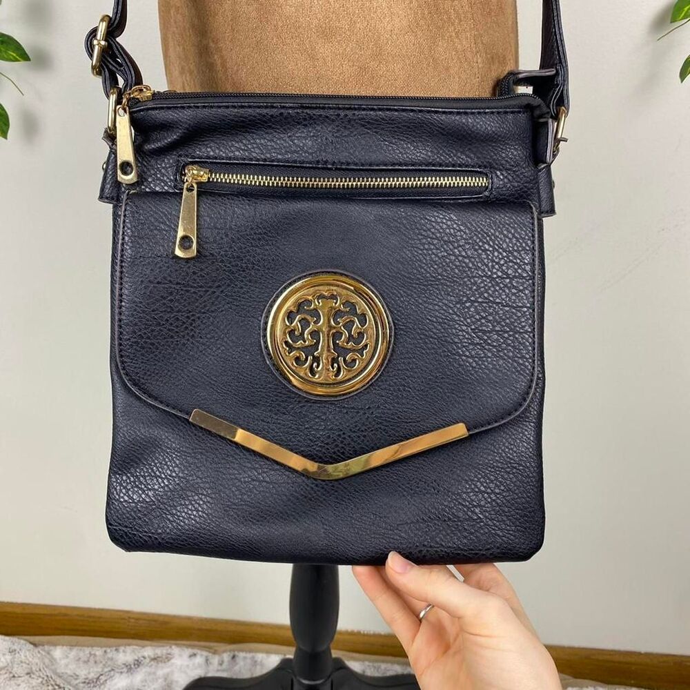 Black faux leather crossbody bag with gold accents intricate circular logo